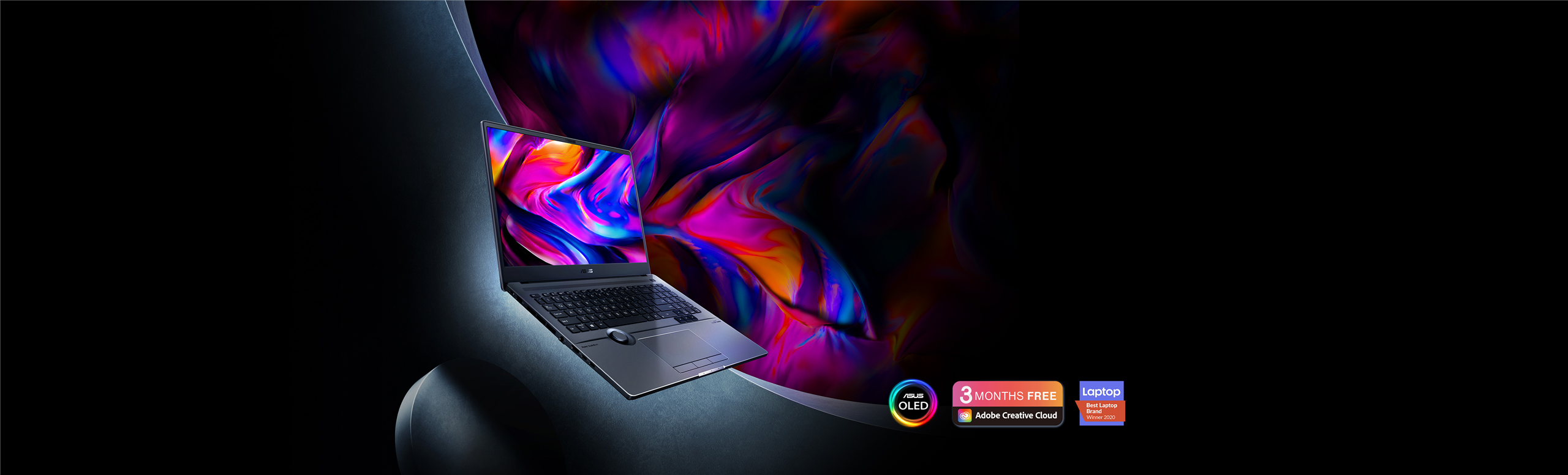 ProArt Studiobook 16 OLED is wide open and faced to the left with colorful whirling lines hovering on the screen. ASUS OLED logo and 3-months-free Adobe subscription alongside the Best laptop brand winner 2020 badge are placed by the laptop.