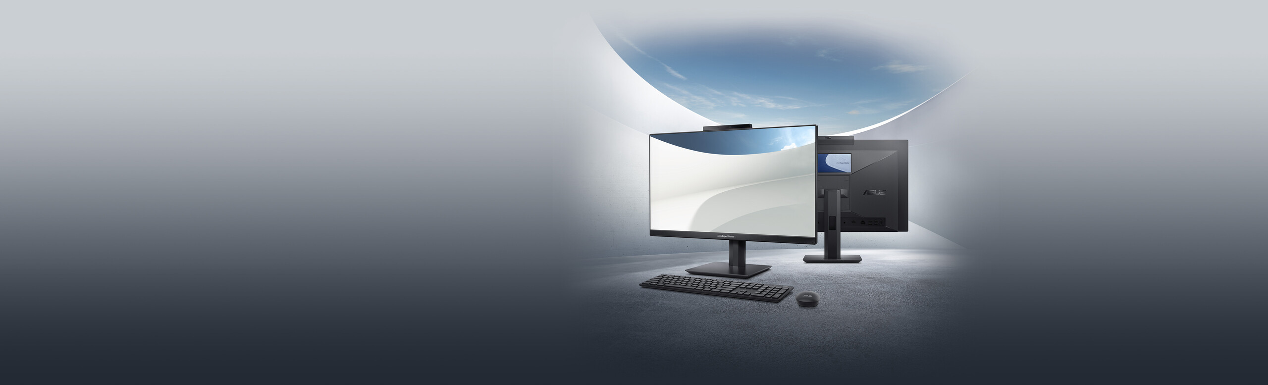 There are two ASUS ExpertCenter AiOs. One of the ASUS ExpertCenter AiO presents a screen with wallpaper in the front with an ASUS wireless keyboard and an ASUS wireless mouse. The other ASUS ExpertCenter AiO presents a customer-facing second screen on the back.