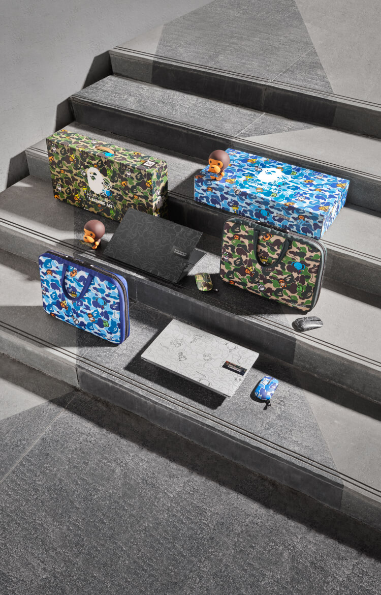 The green and blue laptop bundles are displayed on the grey stairs.