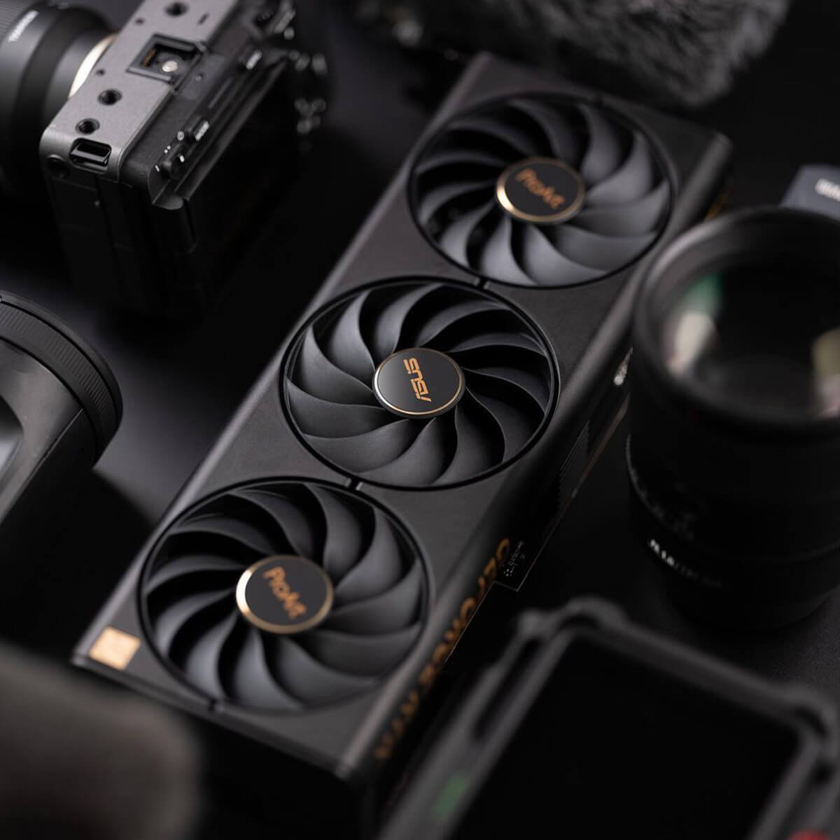 Front view of a ProArt series graphics card lying in the center of other photography tools